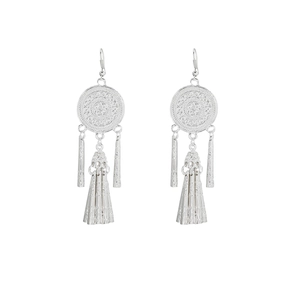 Detail view of ethnic silver tassel earrings with bohemian patterns and long metal fringes