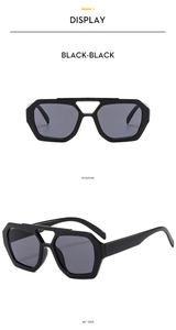 Close-up of black aviator sunglasses with geometric frames and double bridge bars