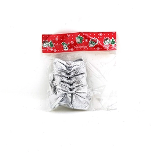 Detail view of silver Christmas bows set in festive red header card packaging
