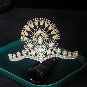 Detail shot of luxury golden peacock bridal crown featuring pearls and rhinestones