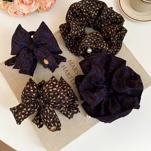 Leopard print scrunchies with pearls and bow hair claws set for elegant hair styling