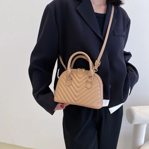 Chic shell-shaped handbag in khaki with V-quilt pattern and gold-tone metal hardware