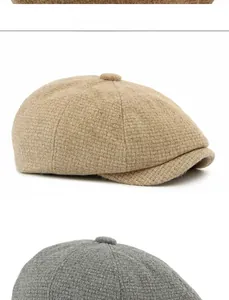 Close-up of wool blend newsboy caps in camel and grey with top button detail