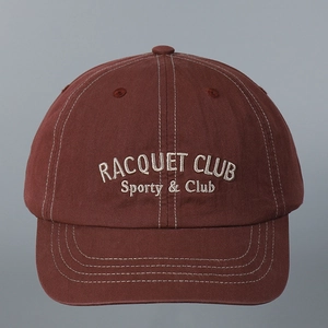 Close-up of a maroon vintage baseball cap with Racquet Club white embroidery detail