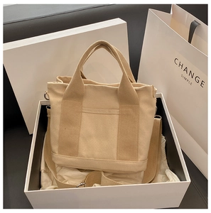 Beige canvas tote bag with detachable strap inside a premium white gift box set