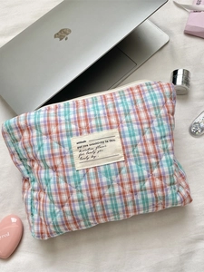 Quilted checkered cosmetic pouch in colorful plaid pattern with soft padded texture