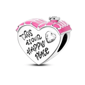 Detailed shot of pink enamel house charm with This is our HAPPY PLACE engraving