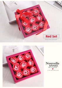 Detail of 9-piece gradient soap rose gift box with red ribbon on light wood background