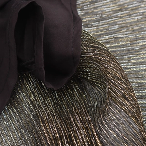 Close-up of deep brown metallic shimmer fabric for sexy V-neck sleeveless party dress
