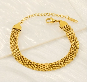 Detailed close-up of gold braided stainless steel bracelet with lobster clasp and K18 tag