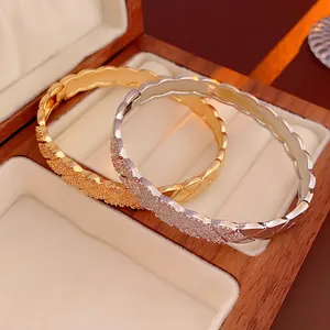 Quilted pattern bangles in gold and silver finish with pavé set zircon crystals