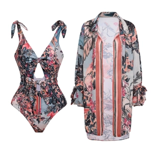Detail of floral one-piece swimsuit with long sleeve cover-up and vintage print design