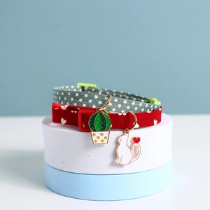 Detail of adjustable star and heart pet collars with cactus and cat pendants on stands