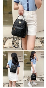 Detail view of black quilted leather mini backpack with gold hardware and top handle