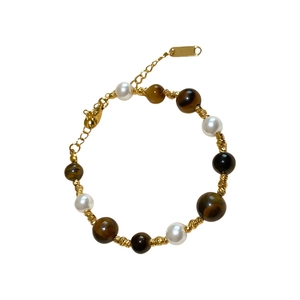 Gold-plated beaded bracelet with tiger eye stones and pearls, featuring adjustable chain