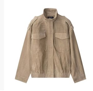 Close-up of khaki suede jacket detailing shoulder epaulets and dual flap pockets
