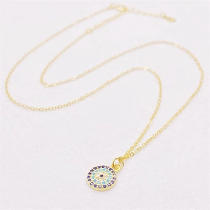 Elegant gold S925 sterling silver evil eye necklace with blue enamel pendant on white background