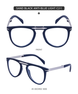 Detail view of foldable blue light blocking glasses with sand black frames and metal legs