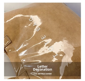 Detail of vintage brown Tyvek tote bag with wrinkled texture and silver TOTE BAG lettering