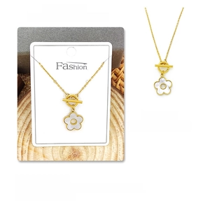 Detail view of a gold titanium necklace featuring a white shell flower pendant and OT buckle
