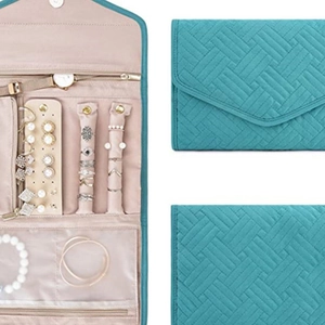 Foldable teal jewelry organizer roll with quilted pattern and pink interior for travel