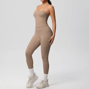 Side view of dark khaki two-piece yoga set with cross-back sports bra and high-waist leggings