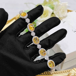 Macro shot of luxury sterling silver bracelet with five oval yellow halo zircon gemstones