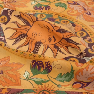 Gros plan d'une tapisserie de tarot soleil bohème montrant la texture et les détails floraux
