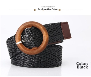 Detail showing the woven black strap and large round wooden buckle of the belt