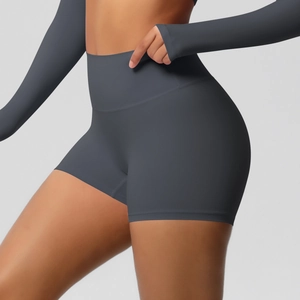 Detail showing dark grey high-waisted yoga shorts with elastic matte fabric and seamless fit