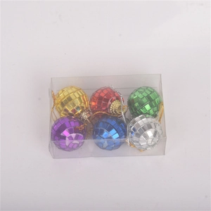 Detailed view of six colorful mini disco ball cake decorations in clear storage packaging