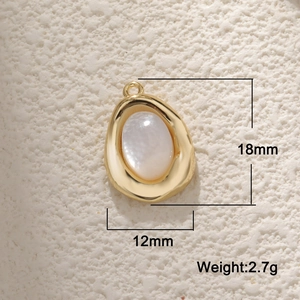 Macro shot of gold teardrop pendant with white inlay showing dimensions 18mm x 12mm