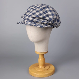 Detailed texture of a blue and white checkered cotton-linen newsboy cap on head model