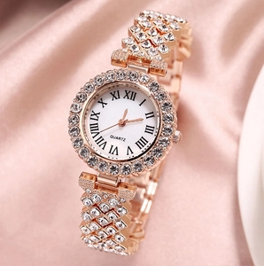 Luxury rose gold quartz watch with full diamond crystals on pink silk background