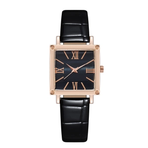 Macro view of square rose gold watch case with black Roman numeral dial and leather strap