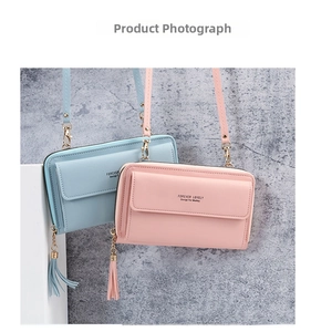 Detail of pink and blue crossbody mini bags with tassels and Forever Lovely text