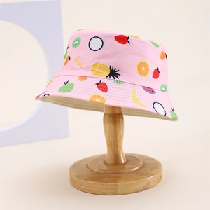 Close-up of pink cotton sun hat featuring vibrant fruit prints and Fresh lettering