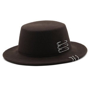 Detail of dark brown wool fedora hat with three silver rings on brim and side pins