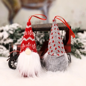 Set of two knitted Christmas gnomes in red and grey colors for holiday tree decoration