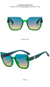 Detail of green cat-eye frame sunglasses with golden V logo and gradient lenses