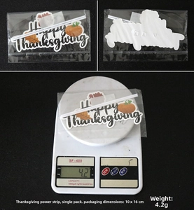 Detail of Happy Thanksgiving cake topper with pumpkin and maple leaf in OPP packaging