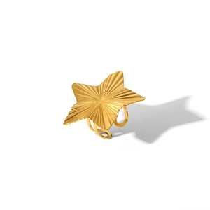 Detailed view of adjustable gold star ring with radiant sunburst textured metal finish