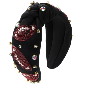 Detail of beaded football patterns and colorful rhinestones on a black knotted headband