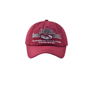 Detailed white dolphin embroidery on a vintage wine red cotton baseball cap brim