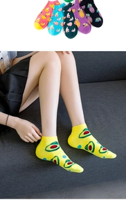 Detailed view of low cut cotton socks with colorful avocado and pineapple fruit patterns