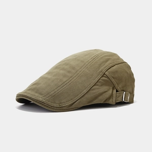 Detail view of olive green herringbone newsboy cap with adjustable side metal buckle