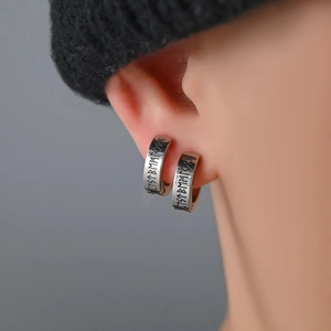 Retro silver titanium steel ear clip with Nordic rune engraving on male model