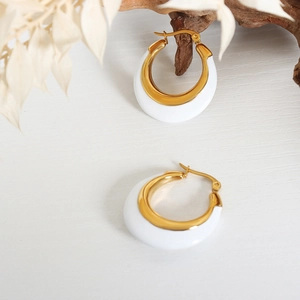 Modern gold-tone hoop earrings with white enamel finish in a minimalist C-shape design