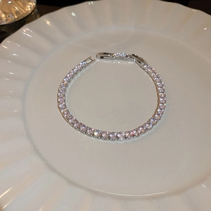 Bracelet tennis en argent avec zircons carrés présenté sur une assiette blanche