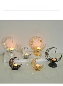 Detailed view of crescent moon iron candle holders with hanging star in gold and silver